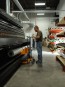 Unloading the paper into the printer with the media roll lifter